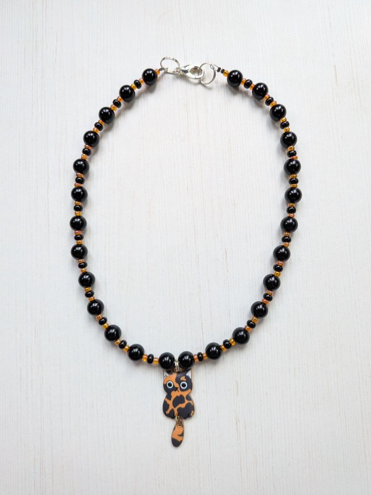 Black and Orange Plastic Beaded Choker Necklace with Metal Cat Pendant